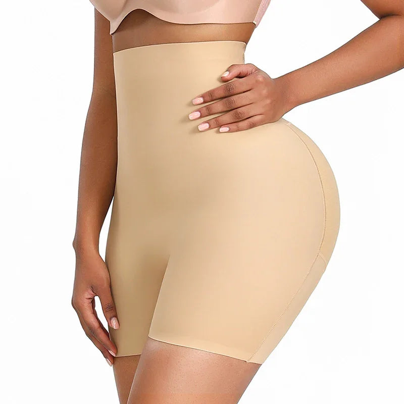 Woman wearing nude high-waisted shapewear shorts smoothing waist and hips