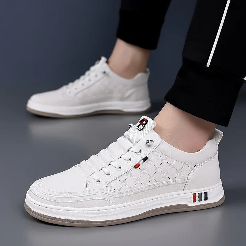 White men's casual sneakers with geometric pattern and red, black accents worn with black pants