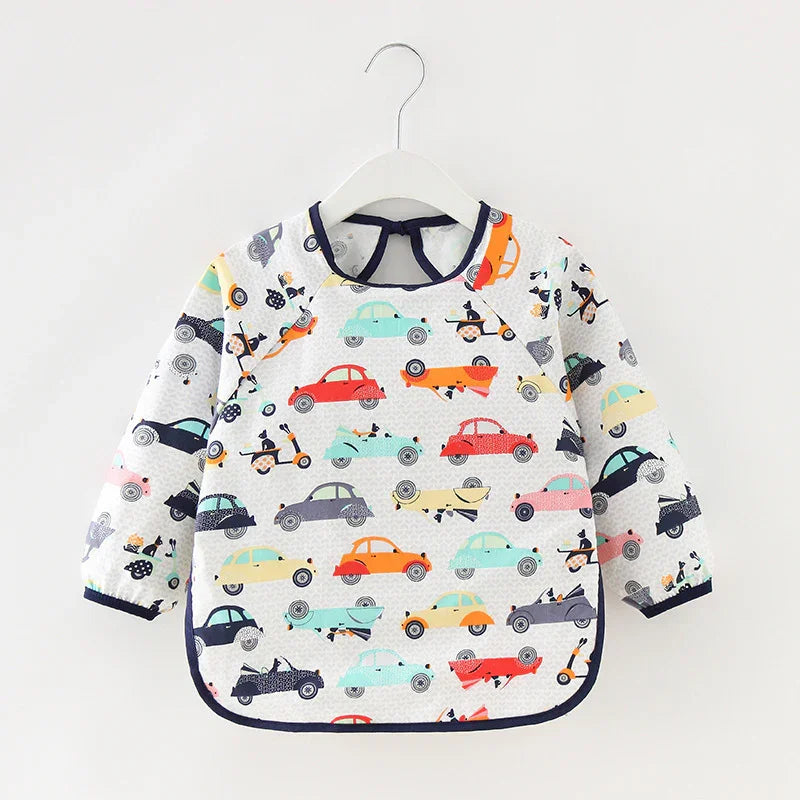 Long-sleeve baby bib with colorful car and scooter print, quilted fabric on hanger