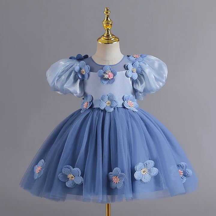Elegant blue tulle toddler dress with puff sleeves and 3D floral appliques on mannequin