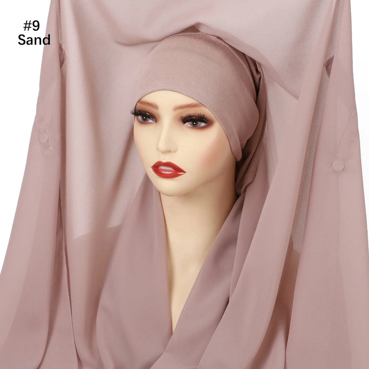 Mannequin wearing sand-colored hijab with matching sheer fabric backdrop