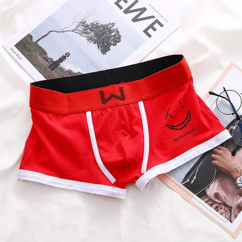 Red men's boxer briefs with white trim and a stitched smiley face design labeled WICKY PRINCE