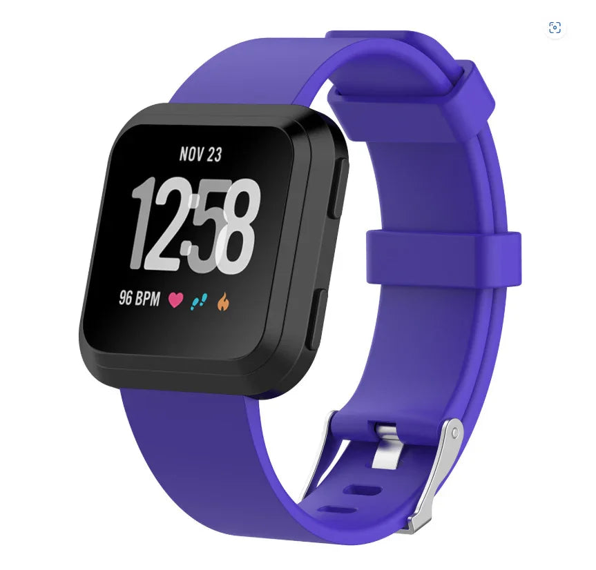 Black smartwatch with purple silicone band showing time, heart rate, and activity icons