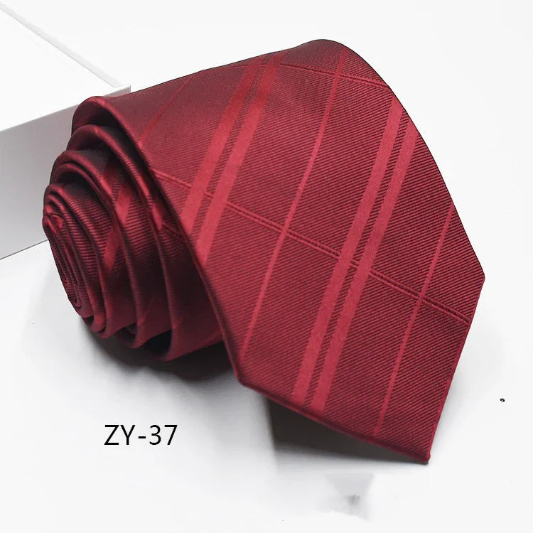 Rolled red men's necktie with subtle diagonal stripes and textured pattern on white surface