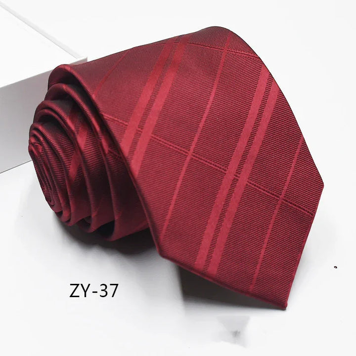 Rolled red men's necktie with subtle diagonal stripes and textured pattern on white surface