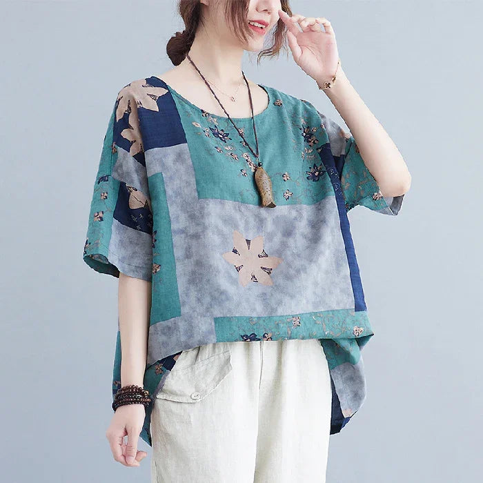 Woman wearing loose floral patchwork short-sleeve top with beige pants and boho accessories