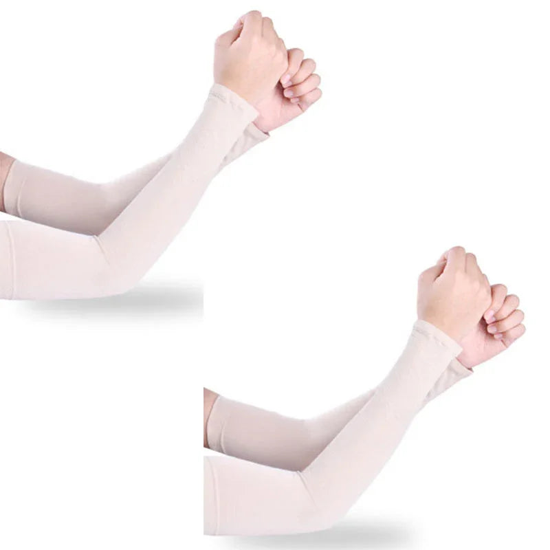 Pair of beige stretchable arm sleeves for sun protection on crossed arms over white background