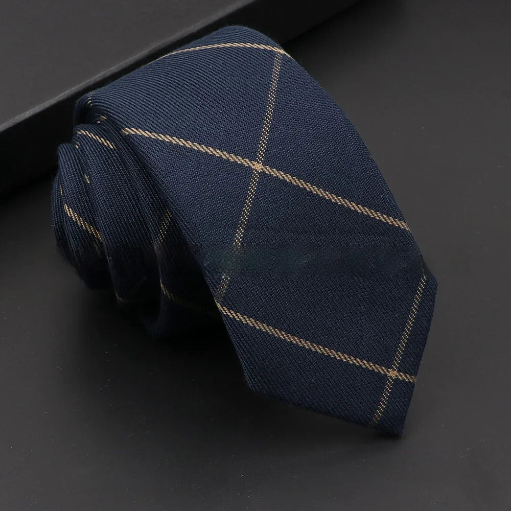 Navy blue tie with subtle beige windowpane check pattern on black surface