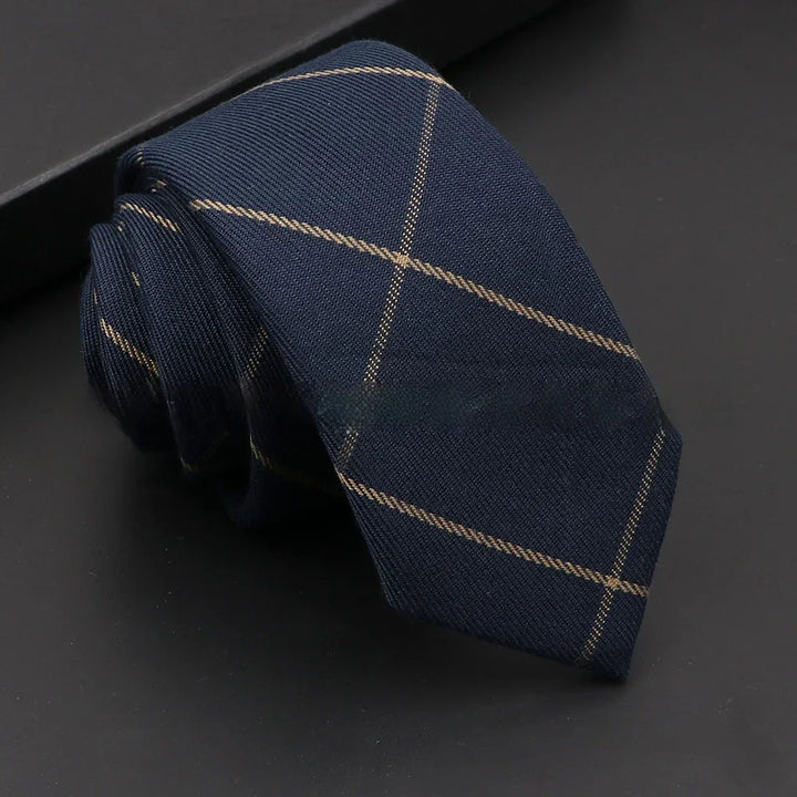 Navy blue tie with subtle beige windowpane check pattern on black surface