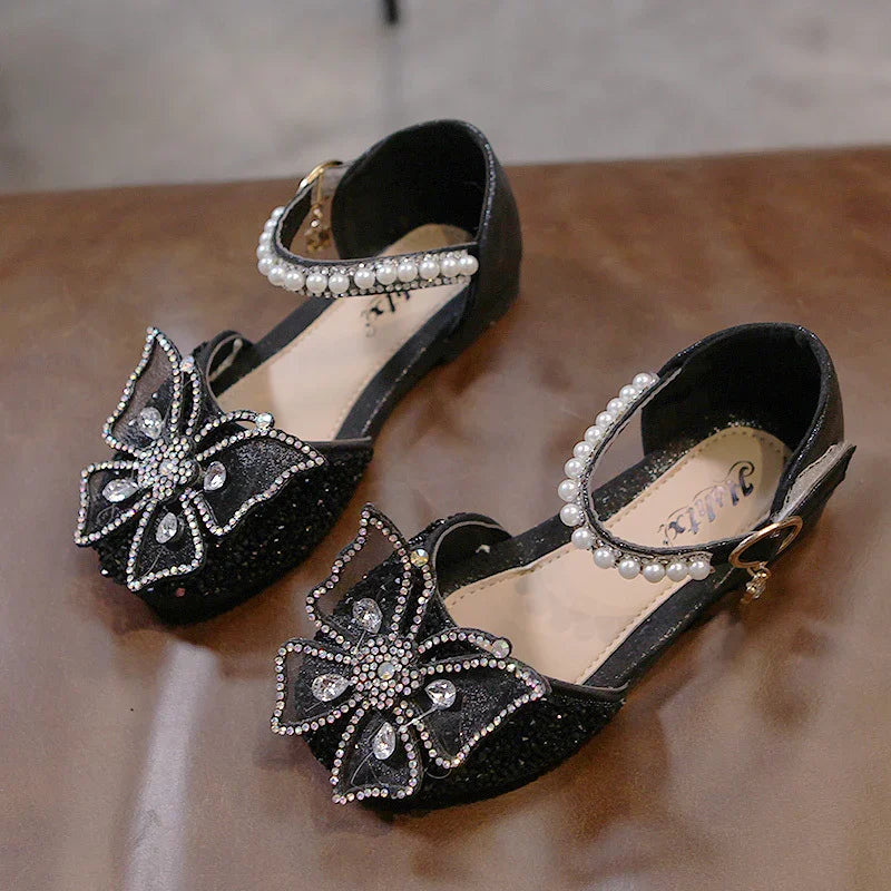 Black girls' dress shoes with pearl ankle straps and large rhinestone butterfly decorations