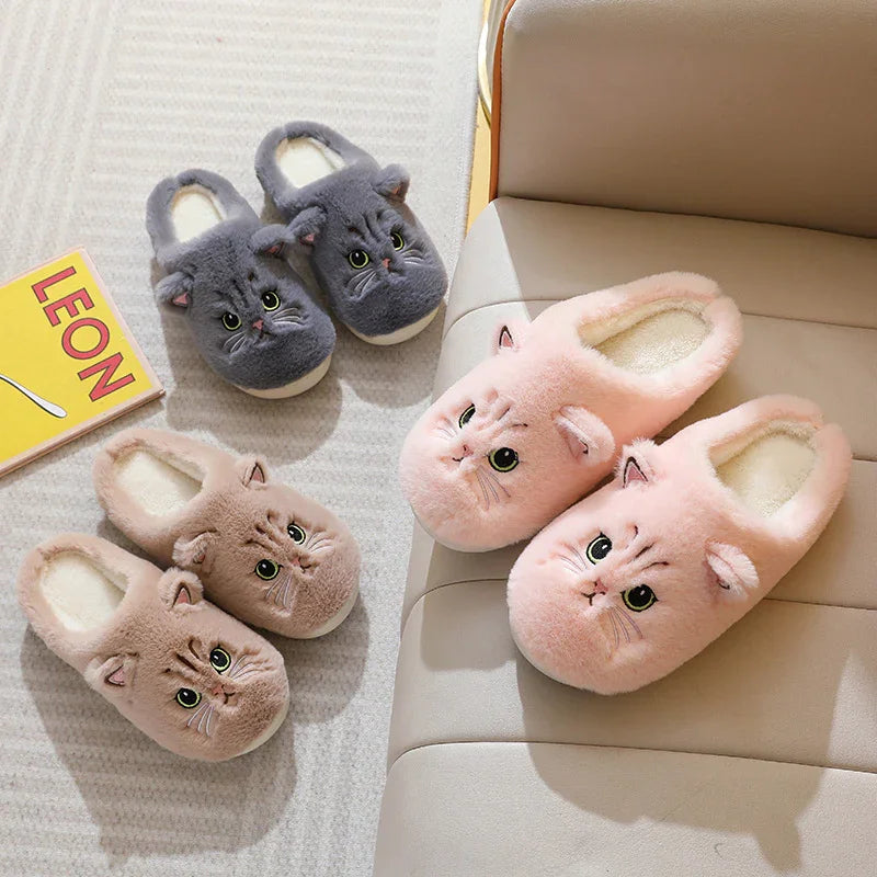 Cozy plush cat slippers in pink, beige, and gray with cute cat faces, displayed on a carpet and sofa