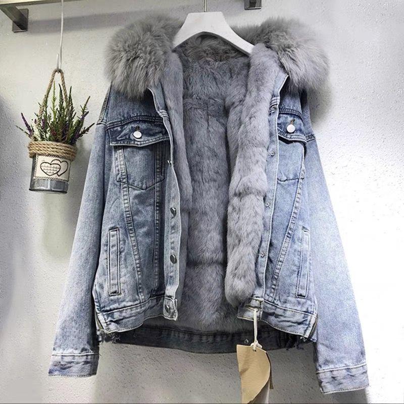 Light blue denim jacket with soft gray fur lining and fur-trimmed collar hanging on hanger