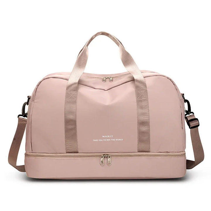 Light pink travel duffel bag with top handles, shoulder strap, and bottom zip compartment