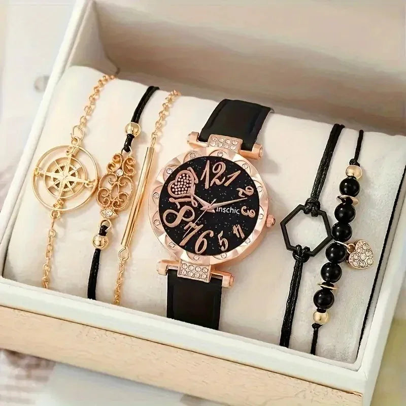 Elegant black and gold wristwatch with decorative gold and black bracelets in a white jewelry box