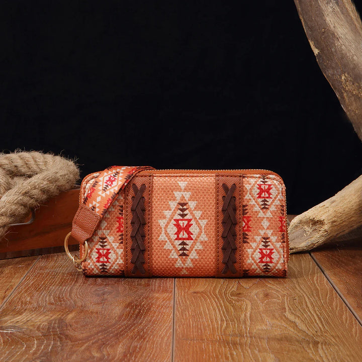 Boho southwestern patterned wallet with braided leather accents on wooden surface