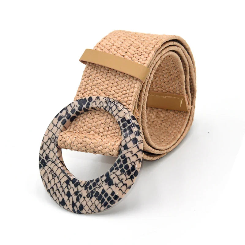 Rolled beige woven belt with large round snake print buckle on white background