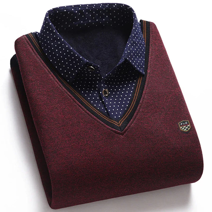 Folded maroon V-neck sweater with black and orange trim over navy blue polka dot dress shirt