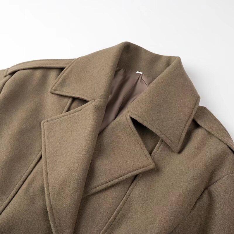 Close-up of a brown wool blend coat with wide lapels and smooth lining detail