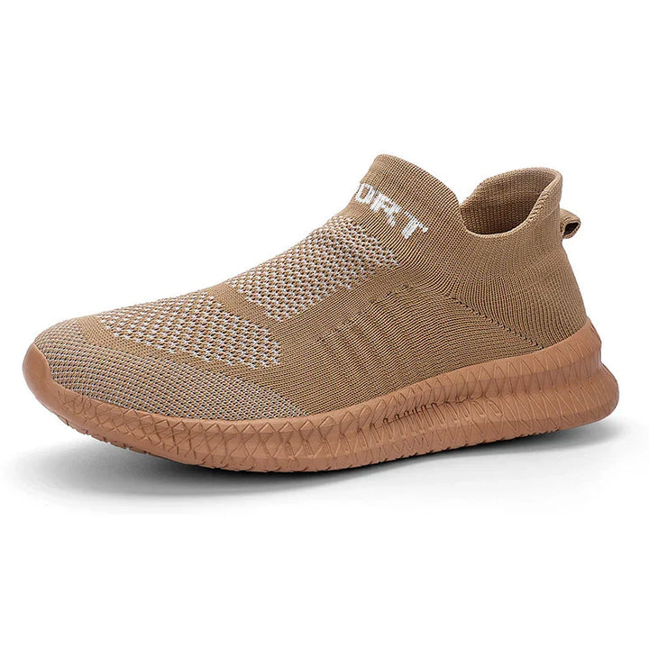 Light brown slip-on knitted sneaker with textured sole and white text on collar