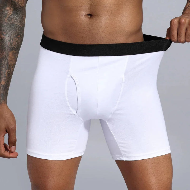 Male model wearing white boxer briefs with black waistband, demonstrating stretch fit
