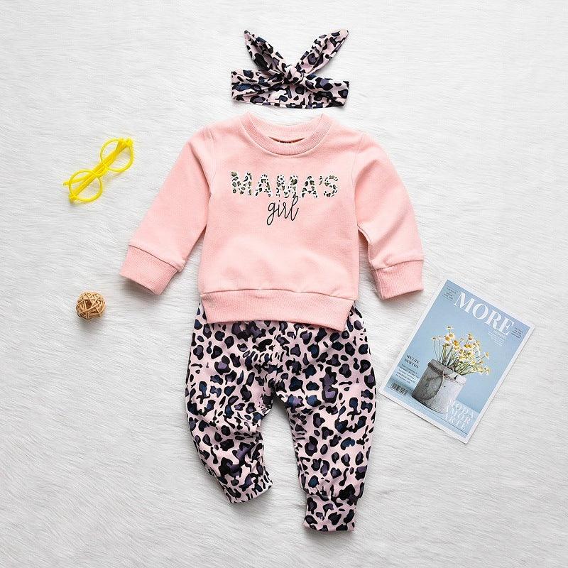 Pink baby outfit set with "MAMAS girl" sweatshirt, leopard print pants and matching headband on white background