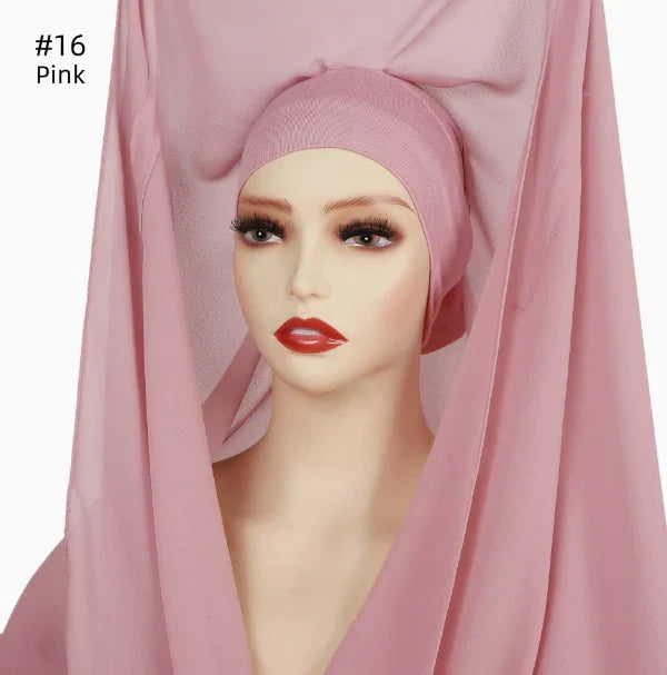 Mannequin wearing a pink hijab with flowing fabric and red lipstick makeup