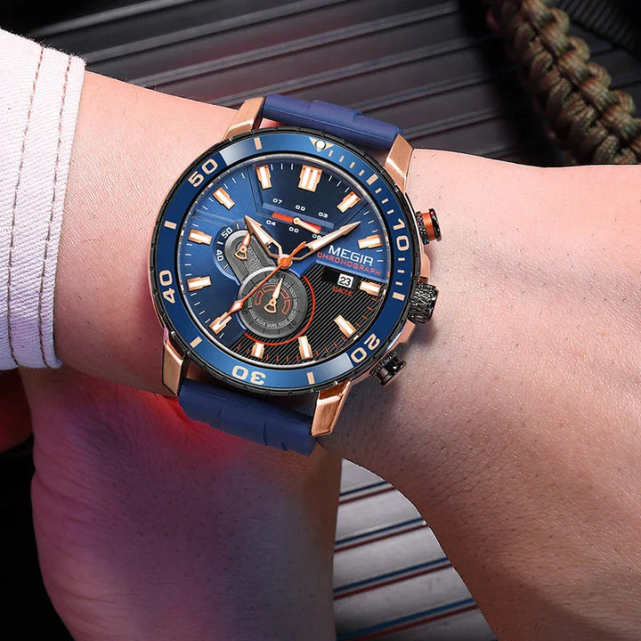 Men's Megir chronograph watch with blue dial, rose gold case, and blue silicone strap on wrist
