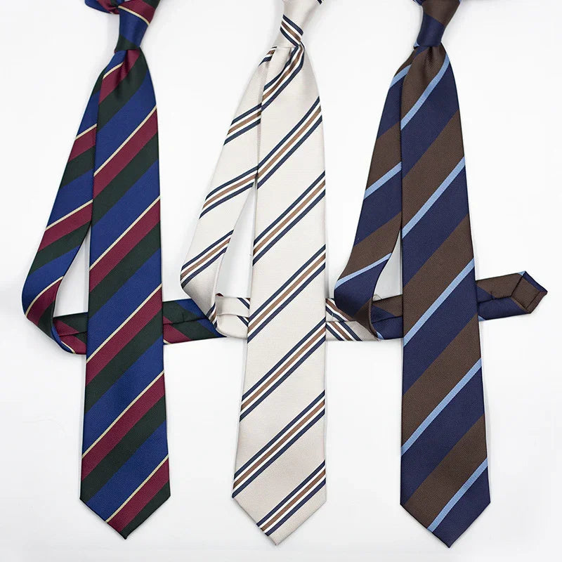 Three striped neckties in blue-green-red, white-blue-brown, and brown-blue color combinations on white background