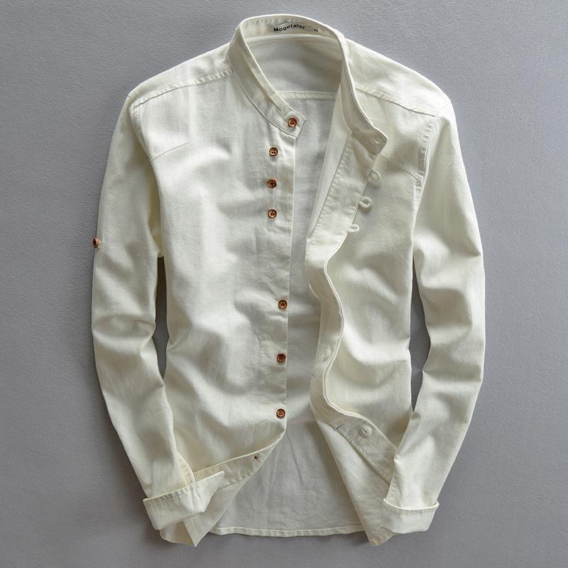 White long sleeve mandarin collar shirt with brown buttons laid flat on gray background