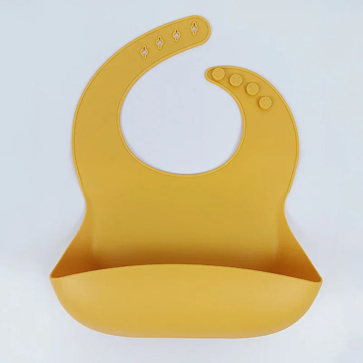 Yellow silicone baby bib with adjustable snap buttons and food catch pocket