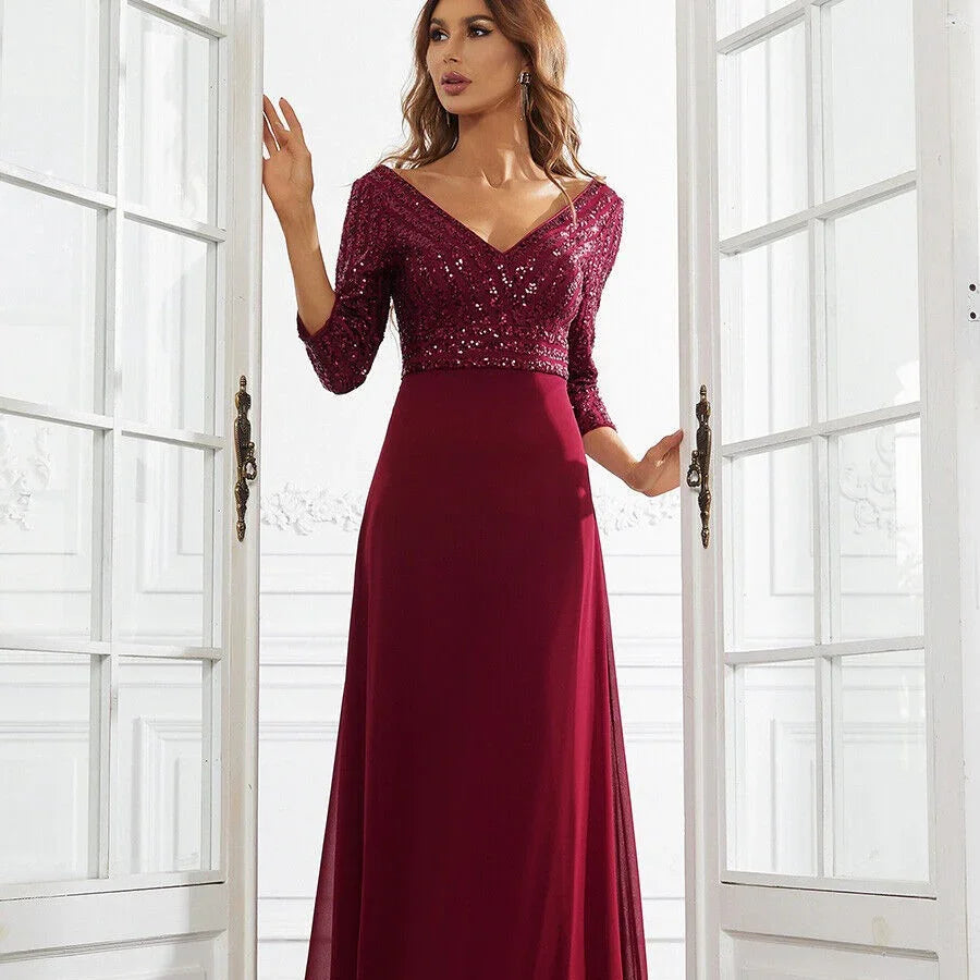 Woman wearing elegant burgundy evening gown with sequin top and three-quarter sleeves in bright room
