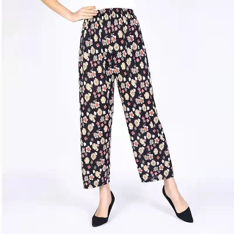 Woman wearing black floral print elastic waist wide-leg pants with black pointed toe heels