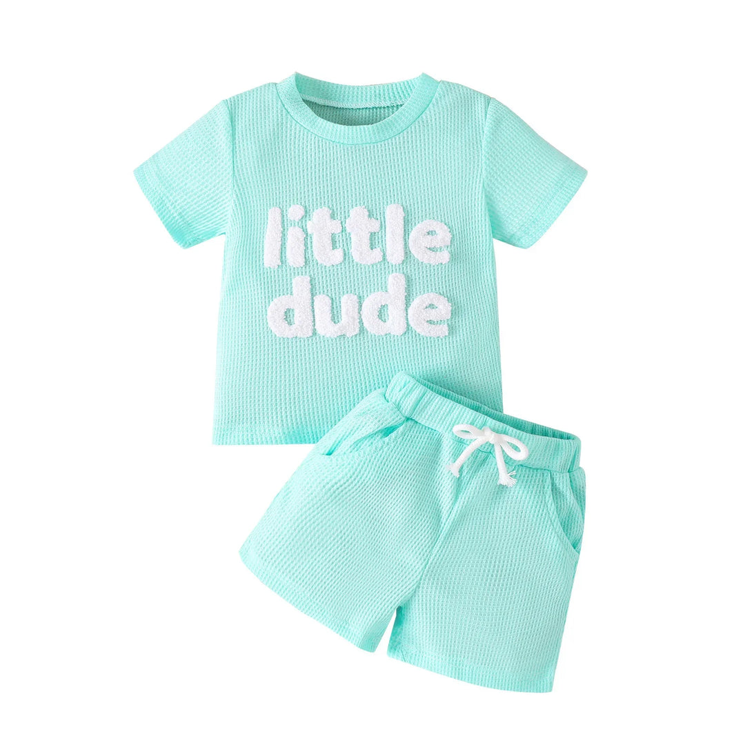 Mint green toddler outfit with textured fabric, short sleeve tee reading 'little dude' and matching shorts
