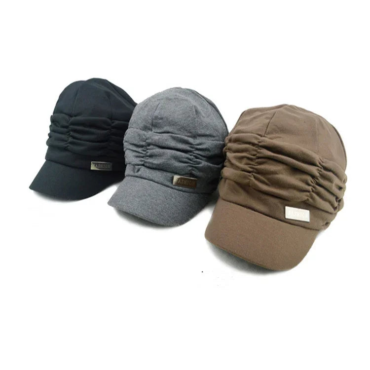 Three ruched fabric caps in black, gray, and brown with a small FASHION label on the front