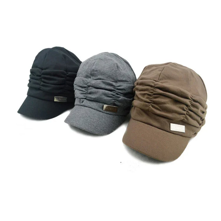 Three ruched fabric caps in black, gray, and brown with a small FASHION label on the front