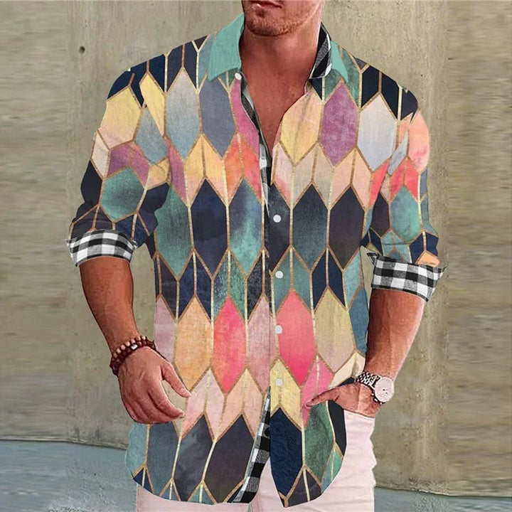 Men's colorful geometric print button-up shirt with rolled checkered sleeves and white pants