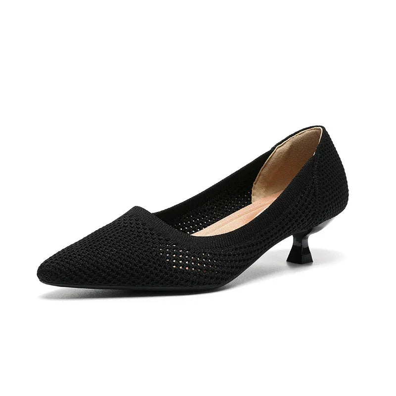 Black pointed-toe kitten heel shoe with woven texture and beige inner lining on white background