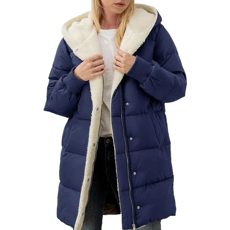 Woman wearing navy blue long puffer jacket with cream sherpa lining and hood, casual winter coat