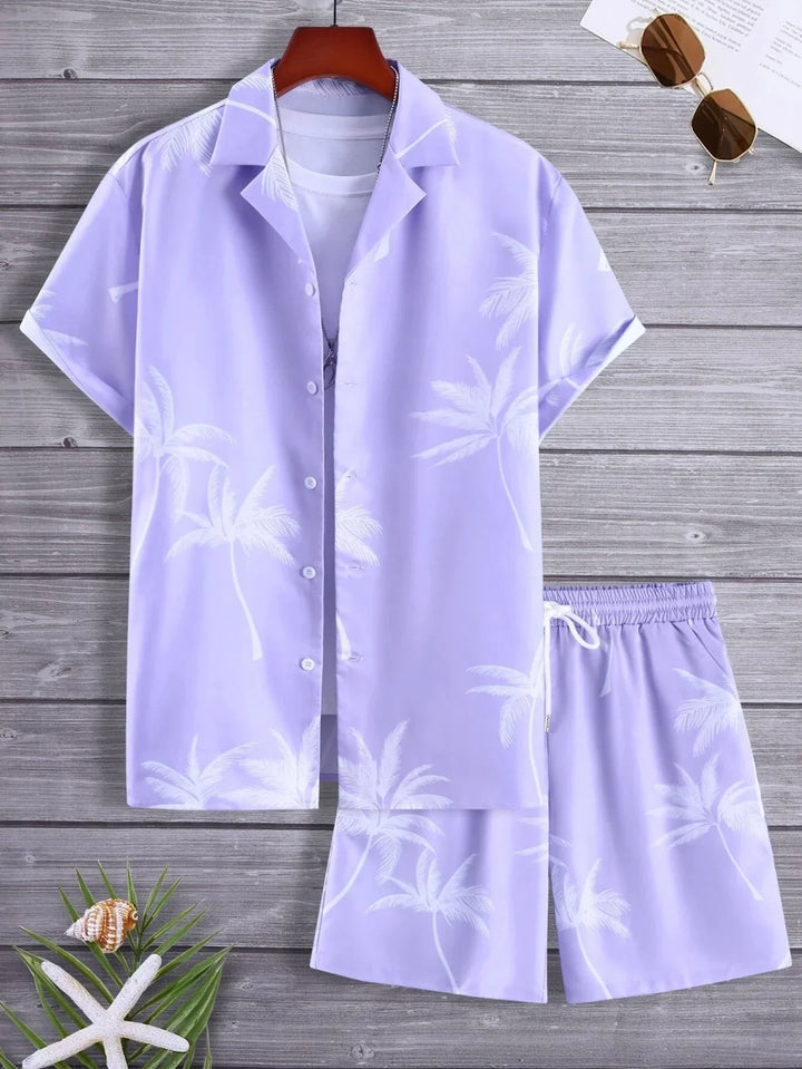 Light purple tropical palm print men’s short sleeve shirt and shorts set styled with sunglasses, seashell, and starfish