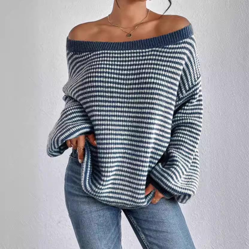 Woman wearing off-shoulder blue and white striped knit sweater with blue jeans against white wall