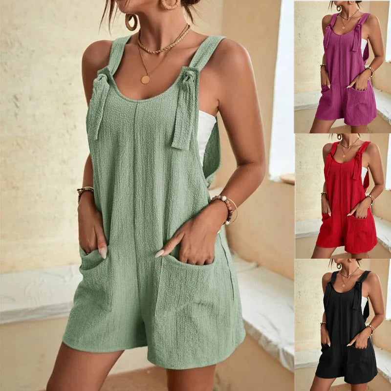 Woman wearing casual sleeveless tie-strap romper with pockets in green, purple, red, and black colors
