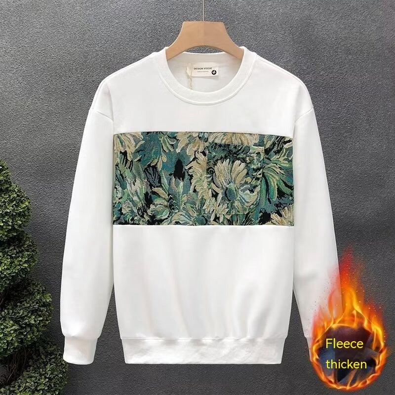 White fleece sweatshirt with green floral tapestry panel and round neckline on wooden hanger
