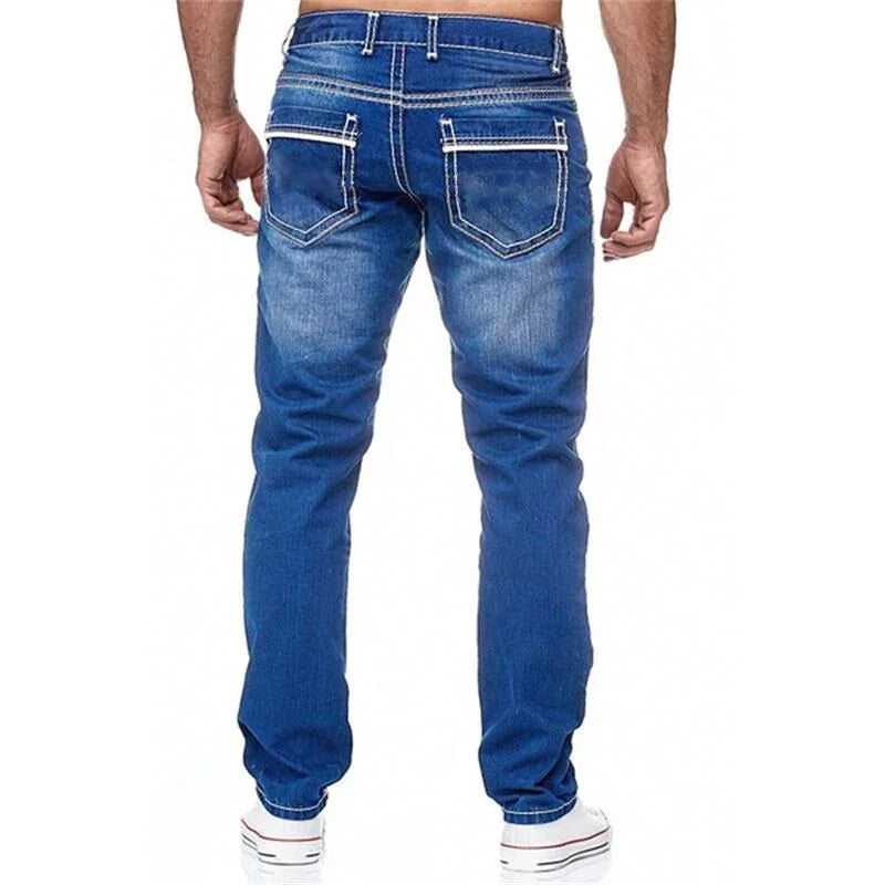 Back view of man wearing blue denim jeans with white stitching and sneakers