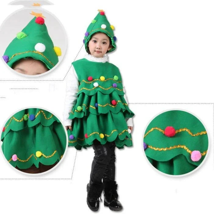 Child wearing green Christmas tree costume dress with colorful pom-pom decorations and matching tree hat