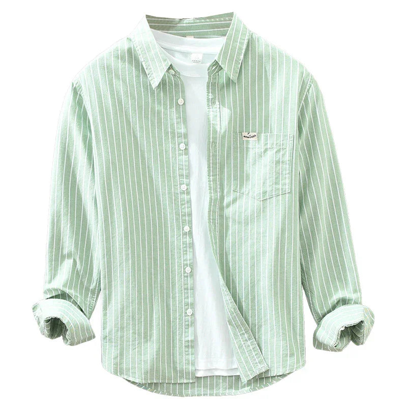 Light green men's striped button-up shirt with rolled sleeves over a plain white t-shirt
