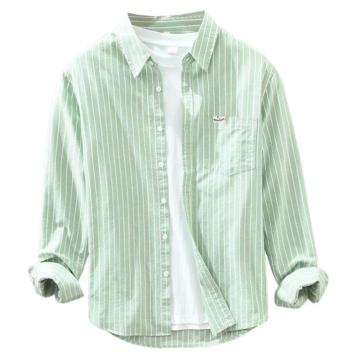 Light green men's striped button-up shirt with rolled sleeves over a plain white t-shirt