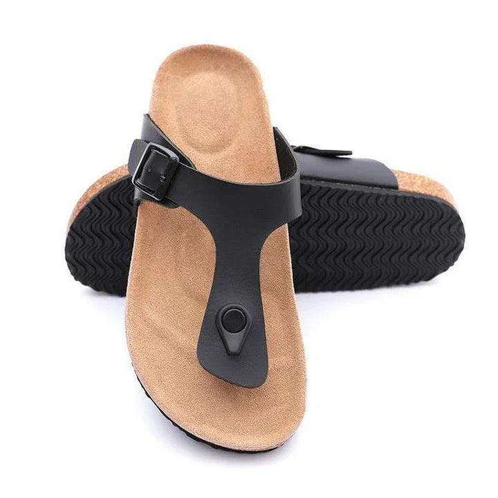 black leather thong sandal with tan suede footbed and black buckle on textured sole