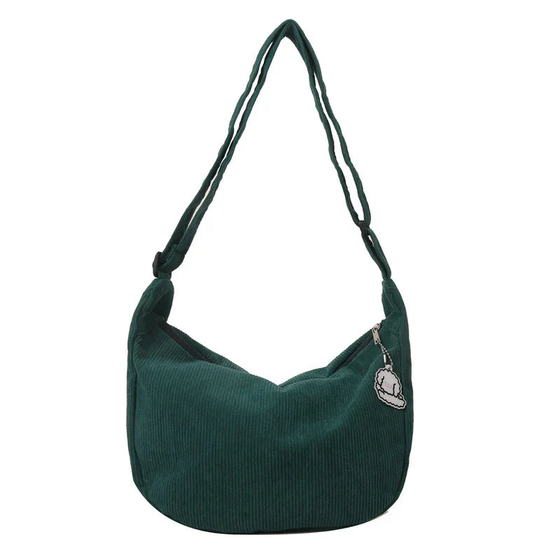 Dark green corduroy shoulder bag with adjustable strap and cartoon zipper charm