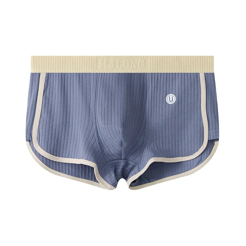 Blue ribbed men's boxer briefs with beige waistband and trim, featuring a small round logo