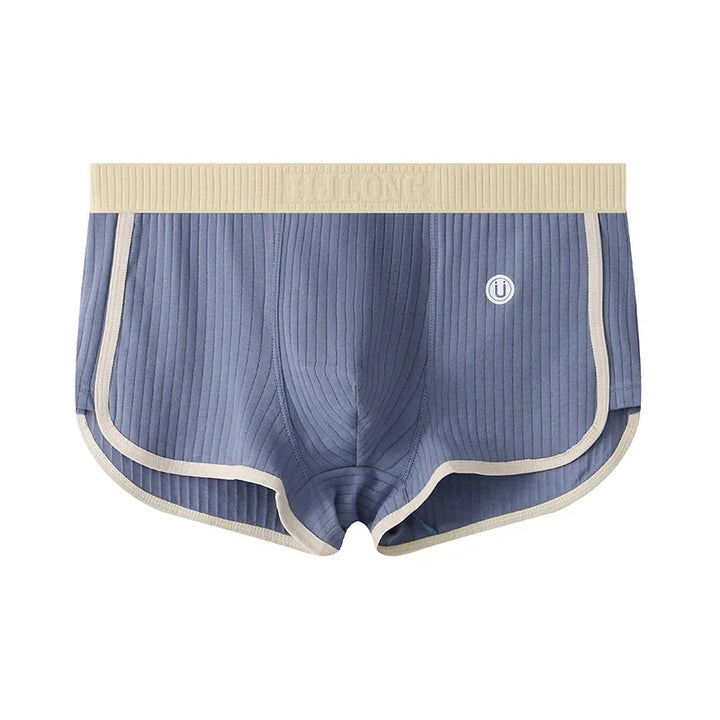Blue ribbed men's boxer briefs with beige waistband and trim, featuring a small round logo